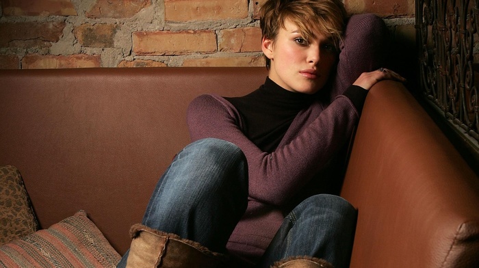 Keira Knightley, boots, sweater, brunette, couch, sitting, short hair, jeans, pants, brown eyes