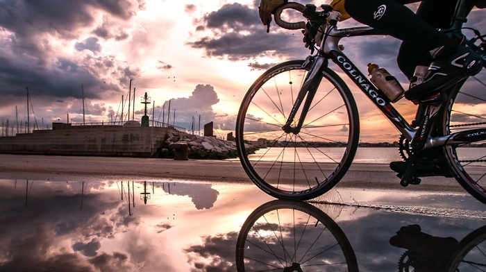 sports, nature, sunset, bicycle, sky, man, water, city, houses, clouds