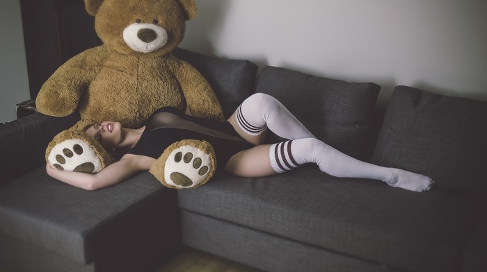 open mouth, black clothing, closed eyes, couch, model, teddy bears, girl, armpits, brunette, lying down