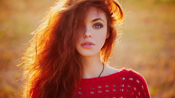 girl outdoors, girl, blurred, redhead, long hair, wavy hair, looking at viewer, sweater, depth of field, sunlight, blue eyes