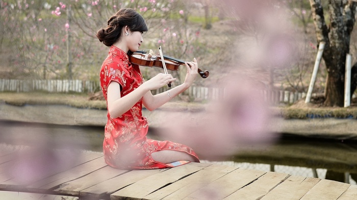 playing, girl outdoors, brunette, girl, red dress, river, wooden surface, sitting, violin, Asian, model, long hair, flowers, trees, pier