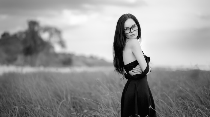 depth of field, black dress, glasses, girl outdoors, girl, girl with glasses, looking away, bare shoulders, monochrome