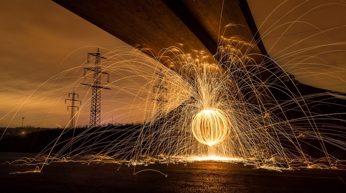 photography, motion blur, utility pole, power lines, bridge, circle, fire, depth of field, sepia, long exposure