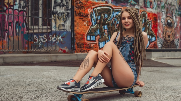 shoes, longboards, girl, ass, sitting, dreadlocks, jean shorts, skateboard, graffiti, tattoo, smiling