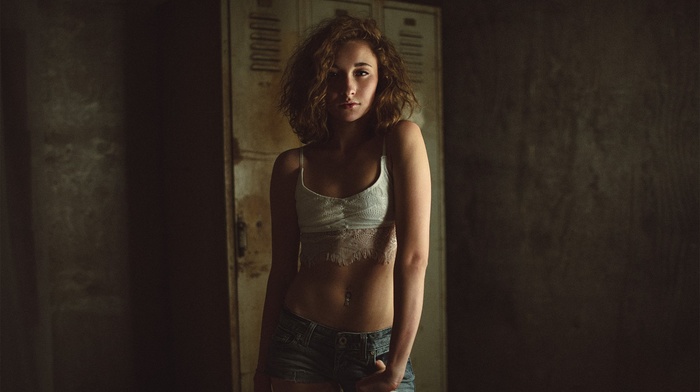 looking at viewer, small boobs, flat belly, portrait, girl, short hair, pierced navel, lockers, jean shorts
