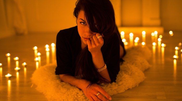 hand on face, rings, depth of field, bracelets, girl, brunette, lying on front, blue eyes, Marina Shimkovich, candles, face, long hair