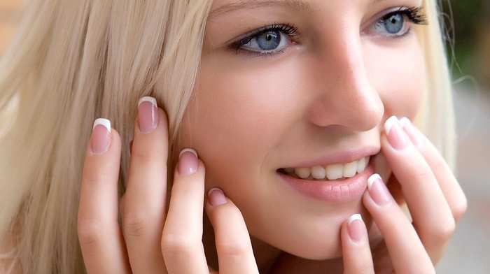 finger on lips, face, blue eyes, pink nails, teeth, smiling, blonde, smooth skin, Alysha A, closeup