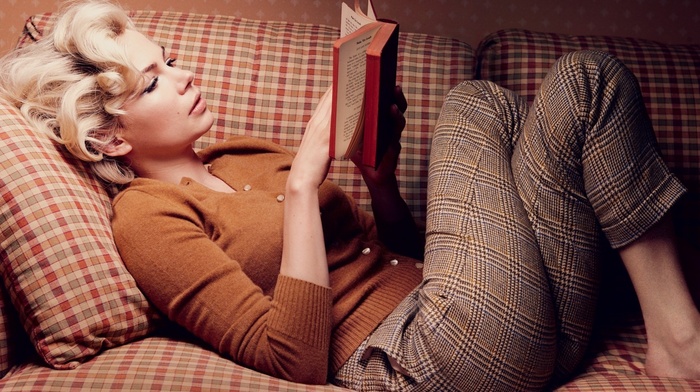 reading, lying on back, girl, Michelle Williams, blonde, sweater, legs  crossed, pants, couch, girl indoors