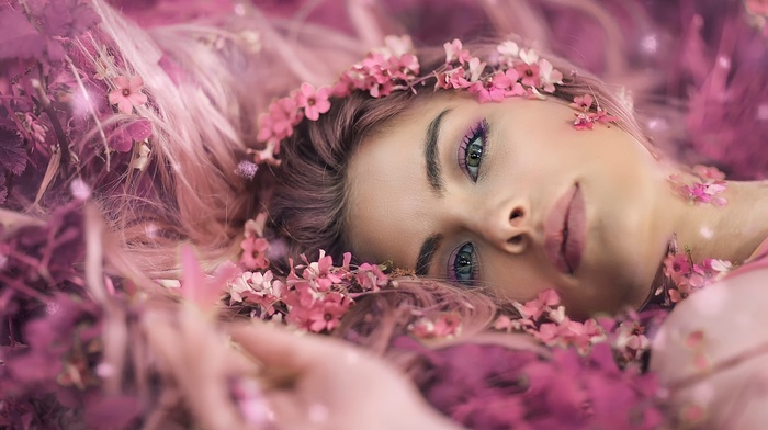 lips, pink flowers, face, lying on back, petals, depth of field, closeup, long hair, flower petals, looking at viewer, flower in hair, music, makeup, lying down, girl, model, brunette