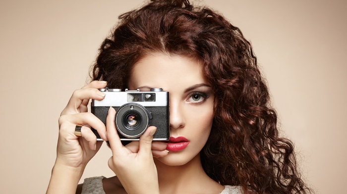 tank top, makeup, simple background, girl, Lorde, camera, long hair, open mouth, brunette, red lipstick, curly hair, model, hand, portrait, looking at viewer, face