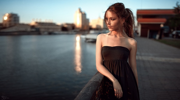 dress, river, bare shoulders, black dress, auburn hair, ponytail, city, depth of field, girl, Georgiy Chernyadyev