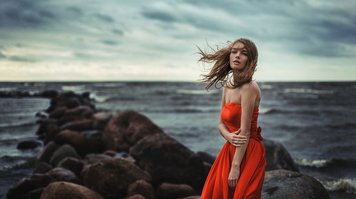 Evgeniy Reshetov, sea, coast, bare shoulders, red dress, girl, emotions, model, brunette, windy