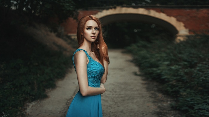 bridge, girl, blue dress, girl outdoors, path, depth of field, dress, Georgiy Chernyadyev, looking at viewer, long hair, redhead, hands in hair