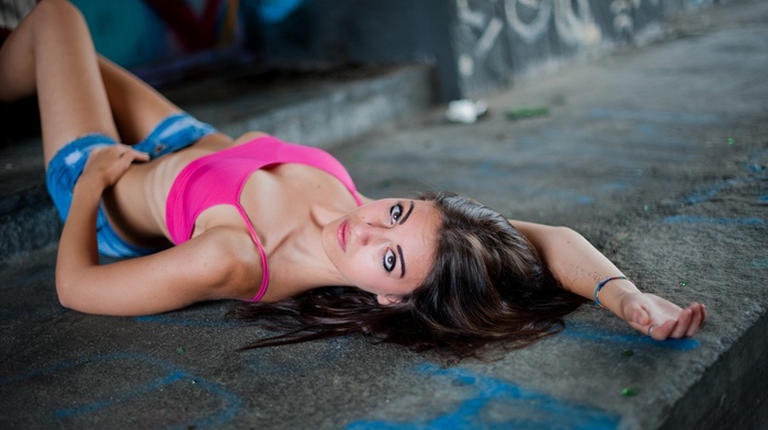 open shorts, pink tops, girl, looking at viewer, depth of field, lying on back, brown eyes, brunette, jean shorts