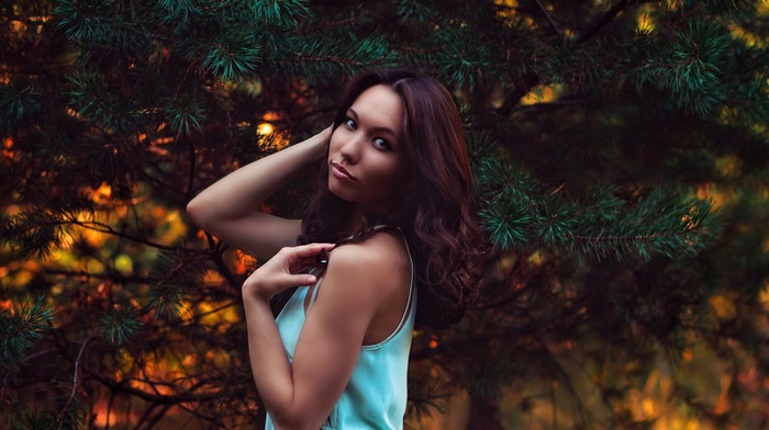 blue clothing, brunette, brown eyes, hands in hair, girl outdoors, looking at viewer, pine trees, bare shoulders, nature, model, girl, long hair
