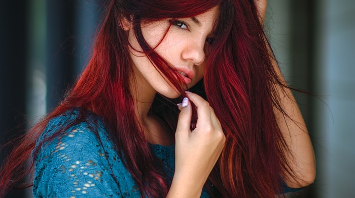 looking at viewer, simple background, hands in hair, girl, Delaia Gonzalez, blurred, face, sweater, long hair, redhead