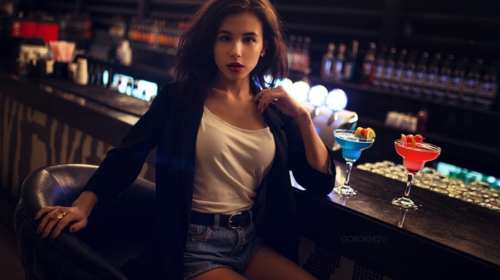 tank top, drink, Ivan Gorokhov, girl, drinking glass, lens flare, long hair, suits, brown eyes, brunette, chair, bar, bottles, alcohol, model, sitting, red lipstick, jean shorts, looking at viewer, open mouth