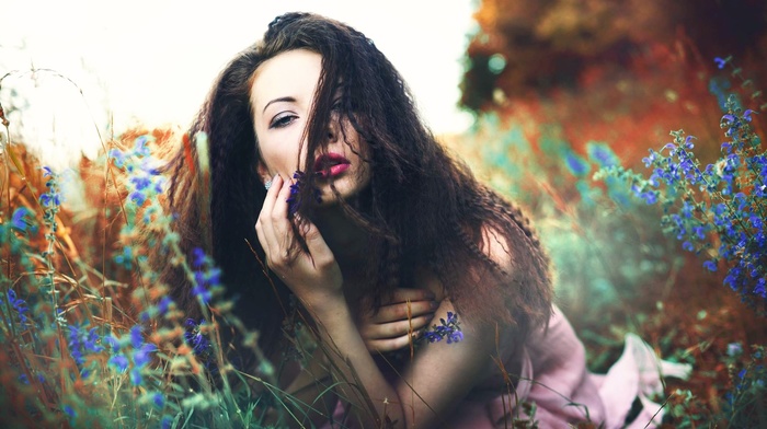 grass, flowers, bare shoulders, wavy hair, lying on front, girl outdoors, Anna Soukupov, open mouth, looking at viewer, red lipstick, brunette, depth of field, nature, girl, dress, model, long hair
