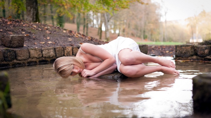 wet body, water drops, fall, fetal position, wet, model, cleavage, minidress, nature, water, bare shoulders, blonde, legs together, girl outdoors, lying on side, trees, leaves, rock, white dress, barefoot, long hair, girl
