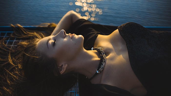 bokeh, black dress, girl outdoors, girl, lying on back