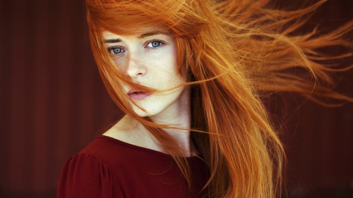 looking at viewer, blue eyes, model, depth of field, face, windy, redhead, straight hair, girl, long hair