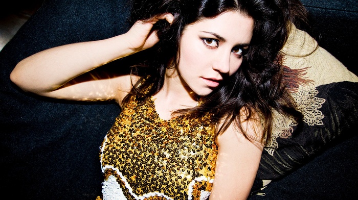 hands in hair, pillow, brown eyes, looking at viewer, bare shoulders, music, yellow dress, lying on back, girl, singer, armpits, open mouth, Marina and the Diamonds, long hair, musician, brunette