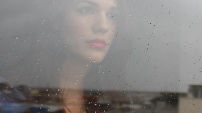 rain, building, portrait, glass, rooftops, looking away, window, girl, red lipstick, face, brunette, blue clothing, urban, reflection, water drops, long hair, model