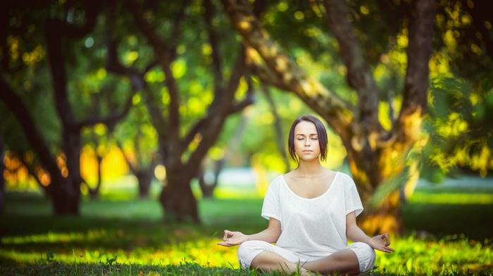 legs crossed, meditation, girl outdoors, white shirt, closed eyes, trees, sunlight