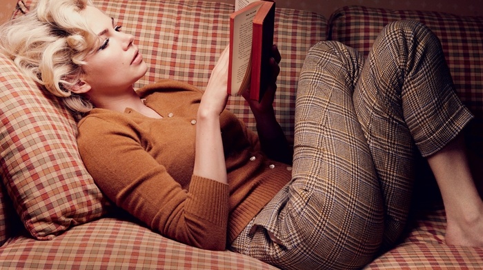 girl indoors, lying on back, blonde, actress, curly hair, sweater, pants, lying down, couch, legs crossed, long hair, books, Michelle Williams, reading, girl