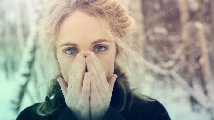 Agnes Obel, musician, girl outdoors, girl, looking at viewer, blonde, braids, hand on face, blue eyes