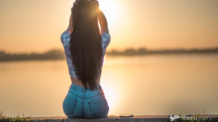 water, girl, back, jeans, sunset, hands on head, sitting