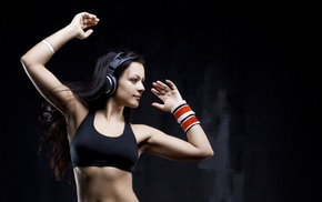 side view, dark hair, sweatband, headphones, sports bra