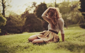 girl outdoors, grass, sitting, hands in hair, skirt, depth of field