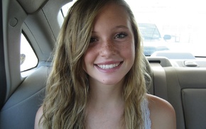 girl, back seat, smiling, looking at viewer, freckles