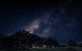 Night Sky Over Grassy Field And Mountains