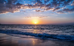 Sunset Glow Over Ocean With Clouds