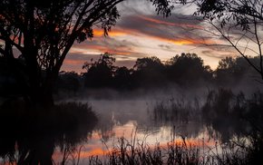 Dark Twilight Lake With Trees And Fog