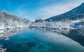 Snowy Mountain Lake With Trees And Clouds
