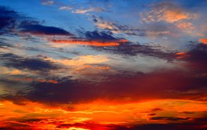 Warm Orange Sunset Sky With Glowing Clouds