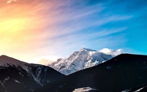Sunset Over Snow-Capped Mountain Peaks