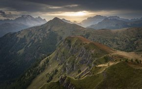 Sun Peaking Through Dolomites Mountain Range