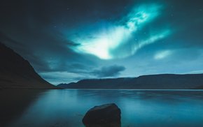 Northern Lights Over Lake And Mountains