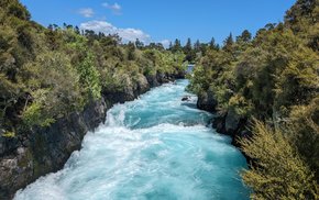 Huka River Flowing Through Green Forest Gorge