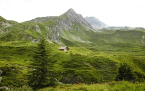 Hut In Green Valley With Blue Sky