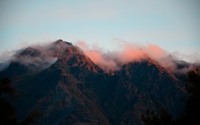 Mountain Range Under Pink Sky And Fog