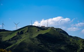 Wind Turbines On Lush Green Hill